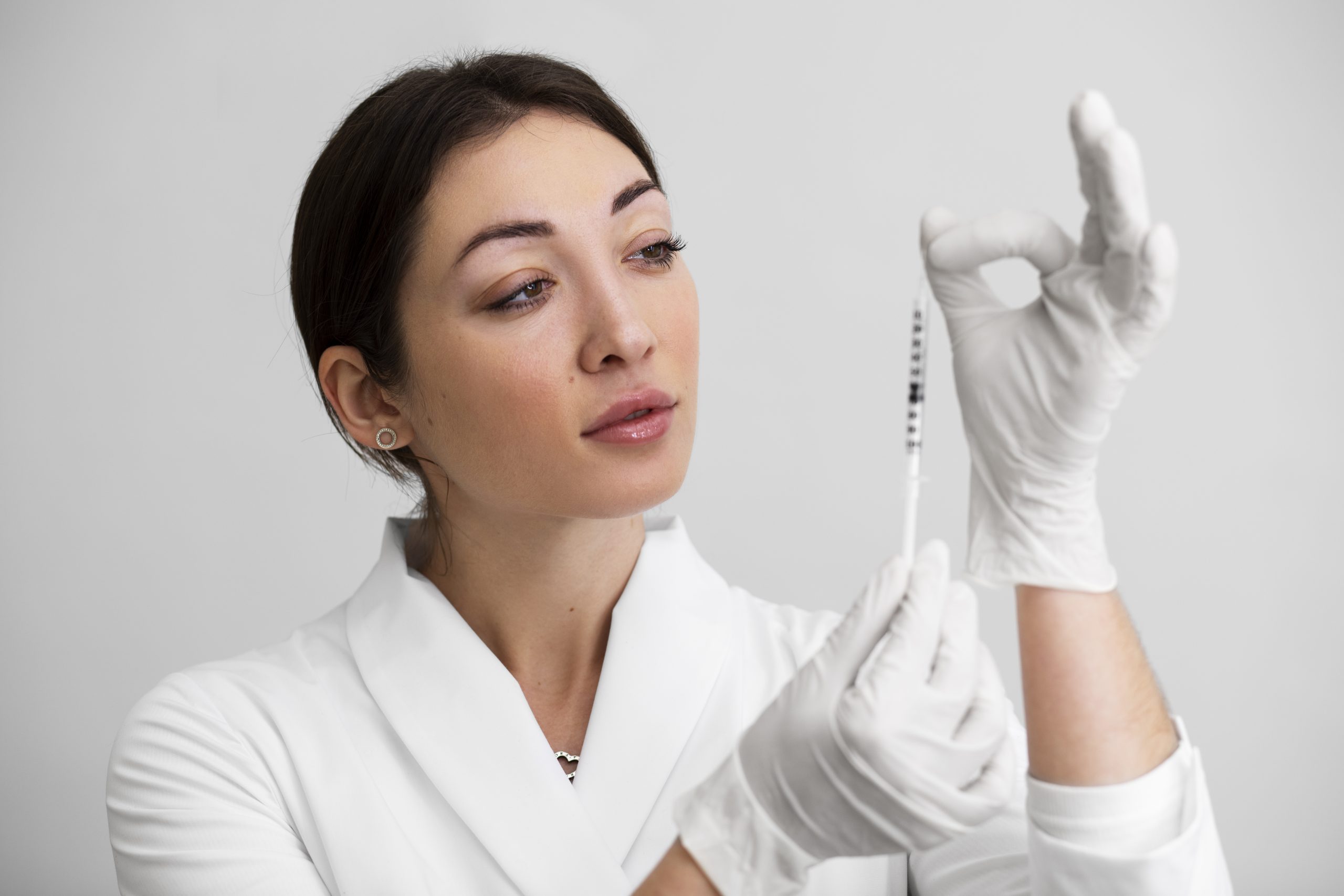 Medical aesthetician holding dermal filler
