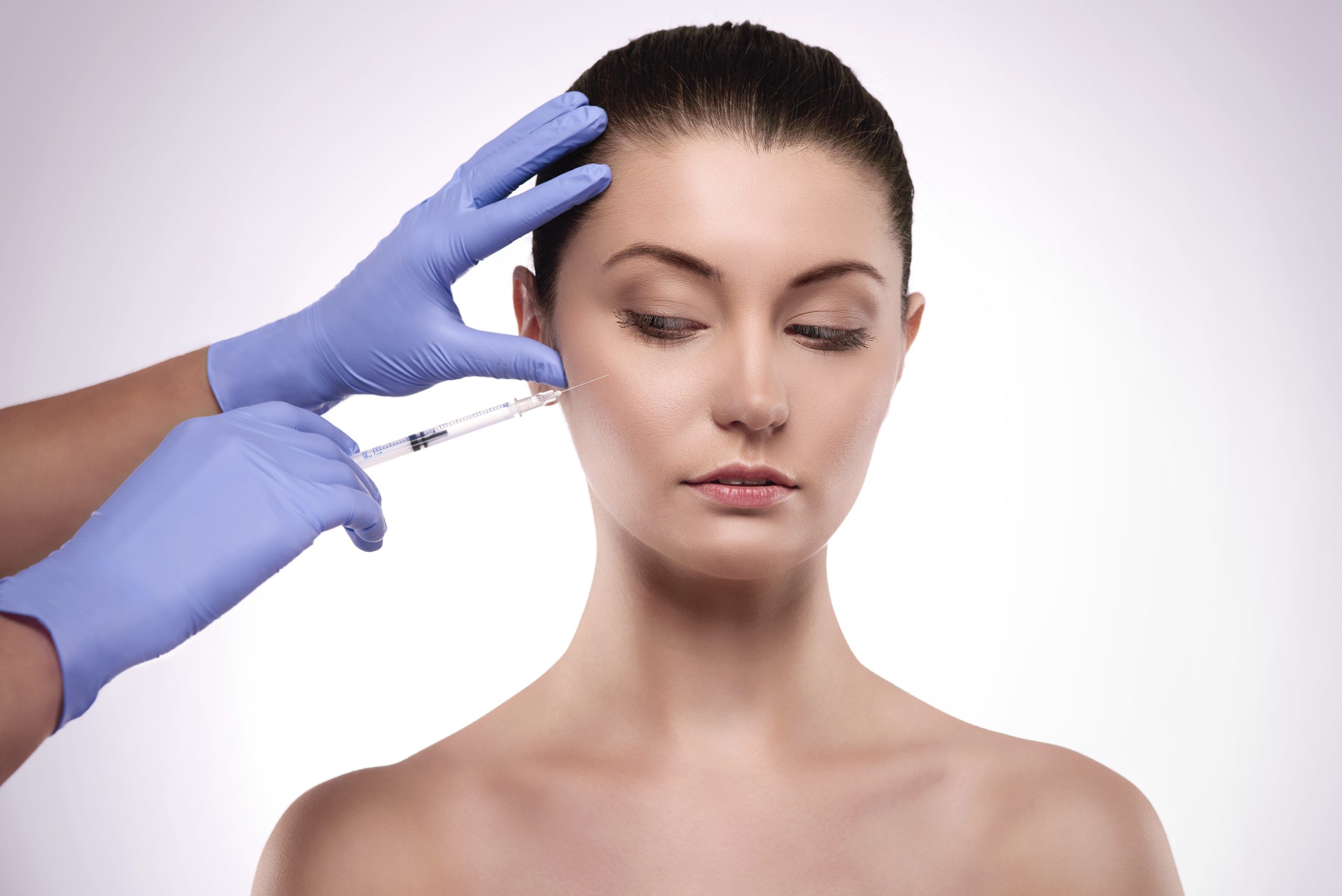Woman looking at Radiesse dermal filler injection