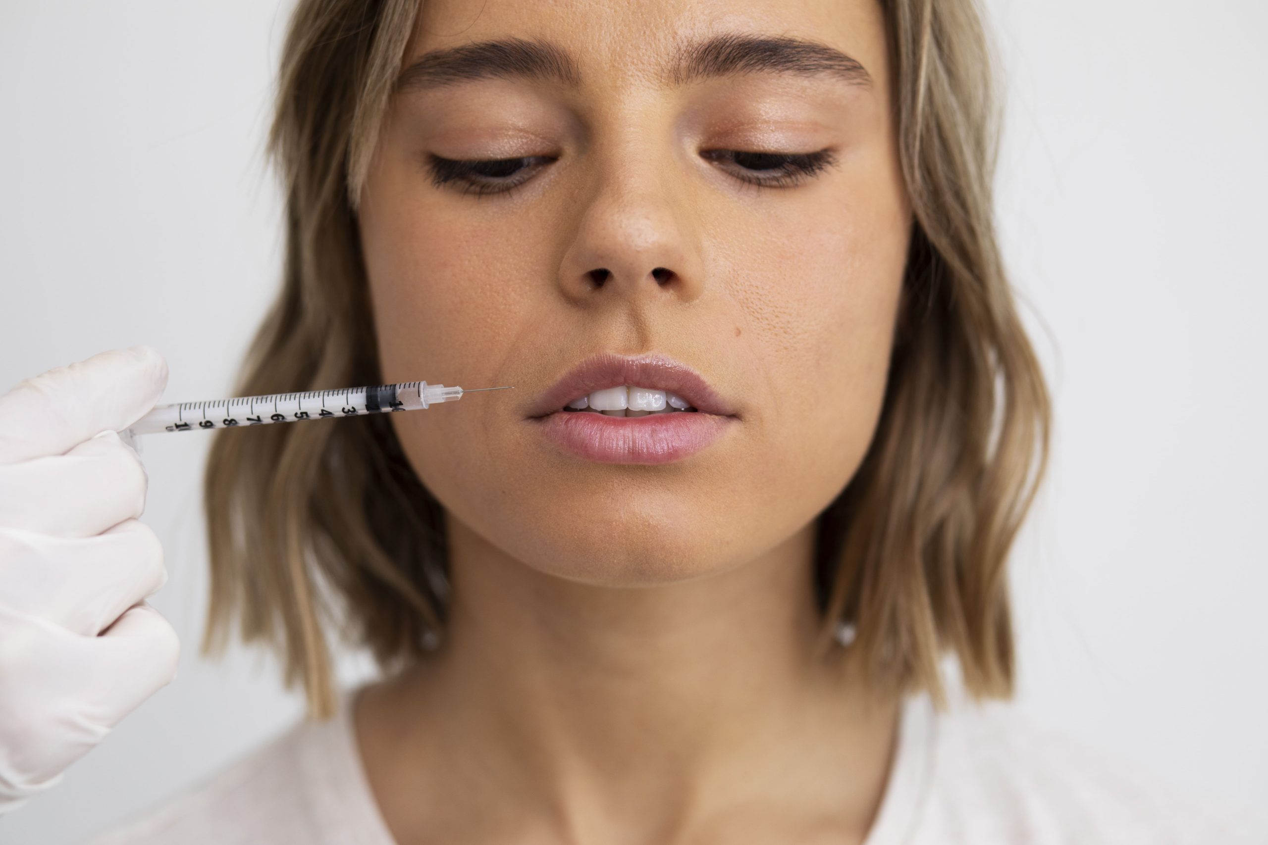 female patient with dermal filler syringe