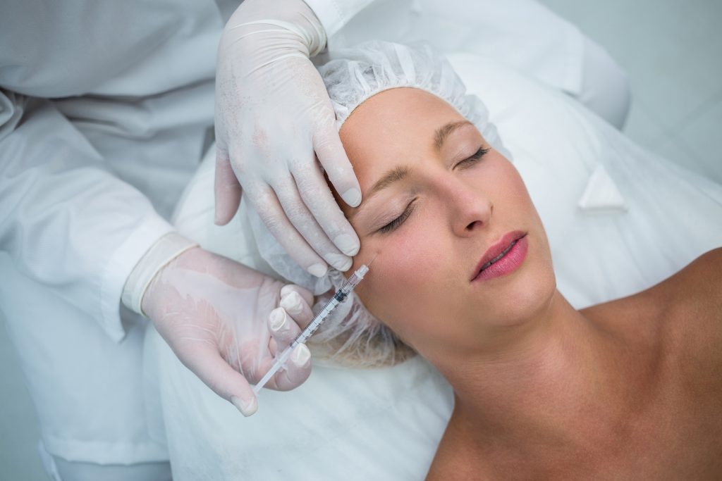 female patient receiving Radiesse cheek filler
